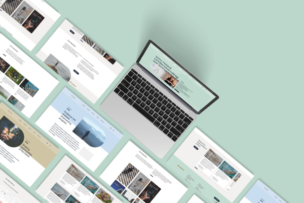 A laptop is laying on top of a green surface featuring Sapere website.