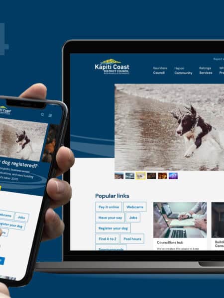 A person holds a smartphone displaying a webpage beside a laptop showing the same website, which features a dog running in water and the text "Is your dog registered?" and "2024.