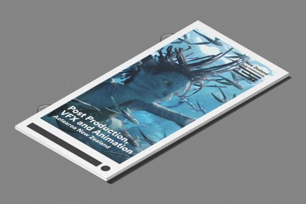 A brochure tilted on a gray surface featuring an animated underwater scene with a character swimming among fish. The text reads, "Post Production, VFX, and Animation, Aotearoa New Zealand.