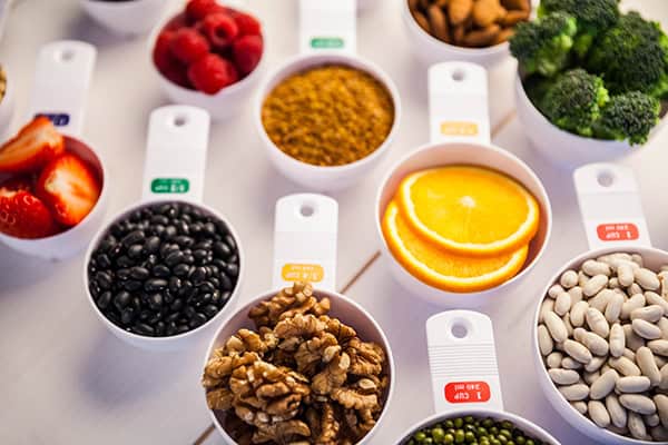 Portion cups of healthy ingredients on wooden table Portion cups of healthy ingredients on wooden table