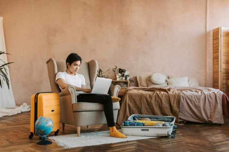 a man using laptop while sitting on the sofa