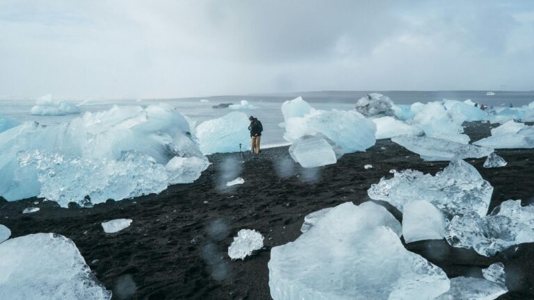 person standing beside body of water