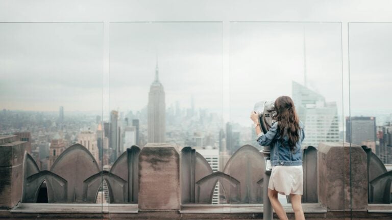 woman in blue denim jacket standing on top of building