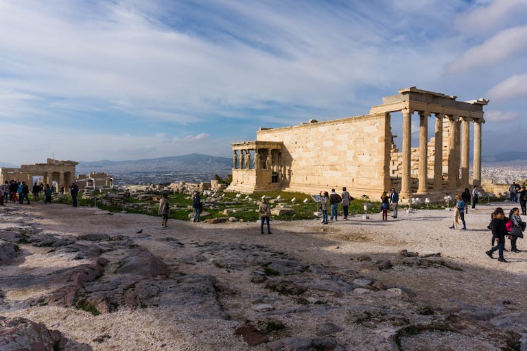 Group of People Standing in Front of Brown Concrete Castle