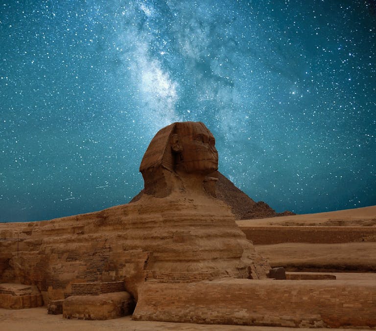 The Great Sphinx of Giza beneath a captivating Milky Way night sky.