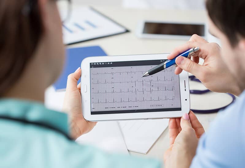Analyzing Electrocardiogram On A Tablet An image that shows Analyzing Electrocardiogram On A Tablet