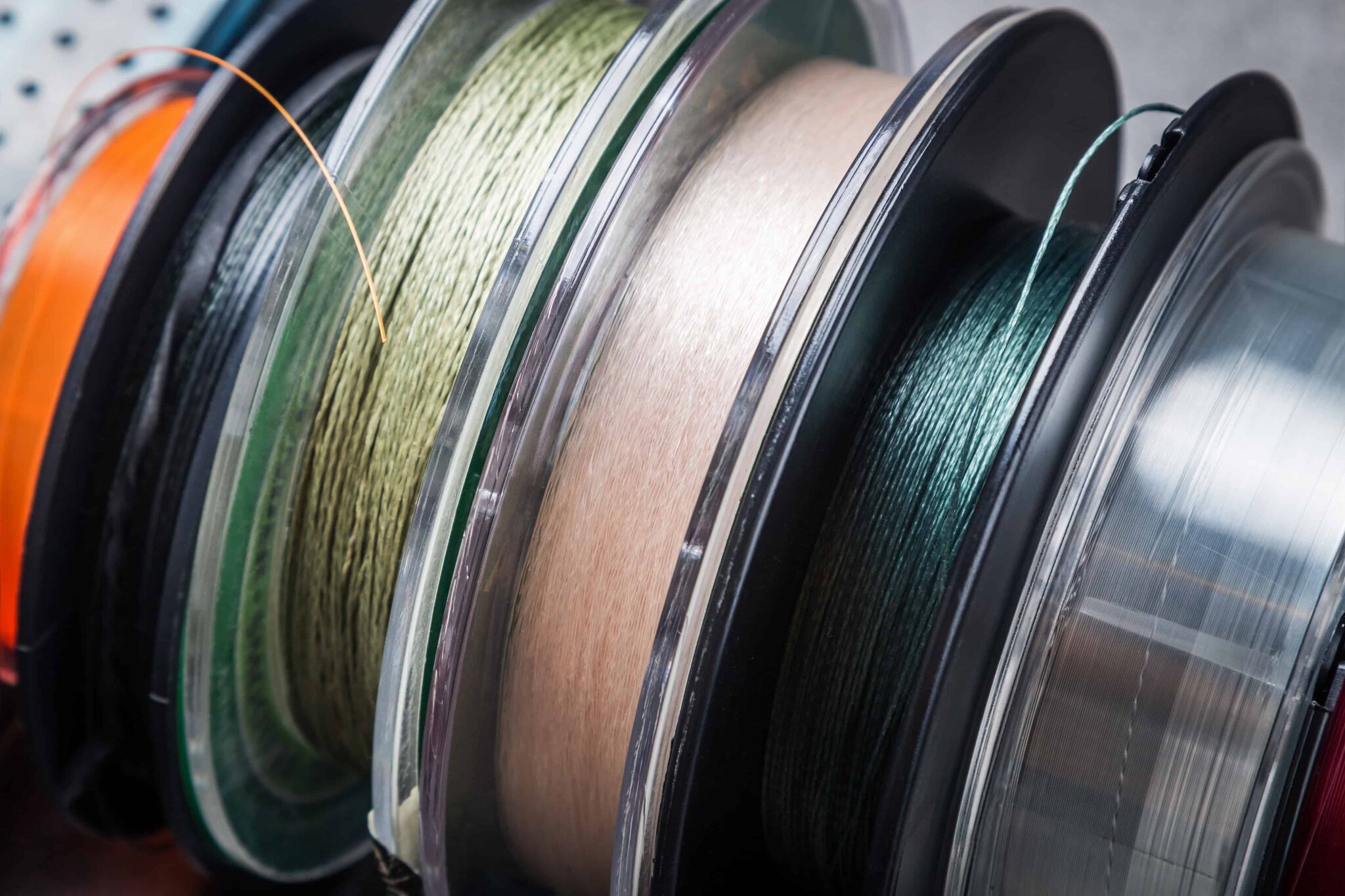 Different fishing lines and braided cords on reels