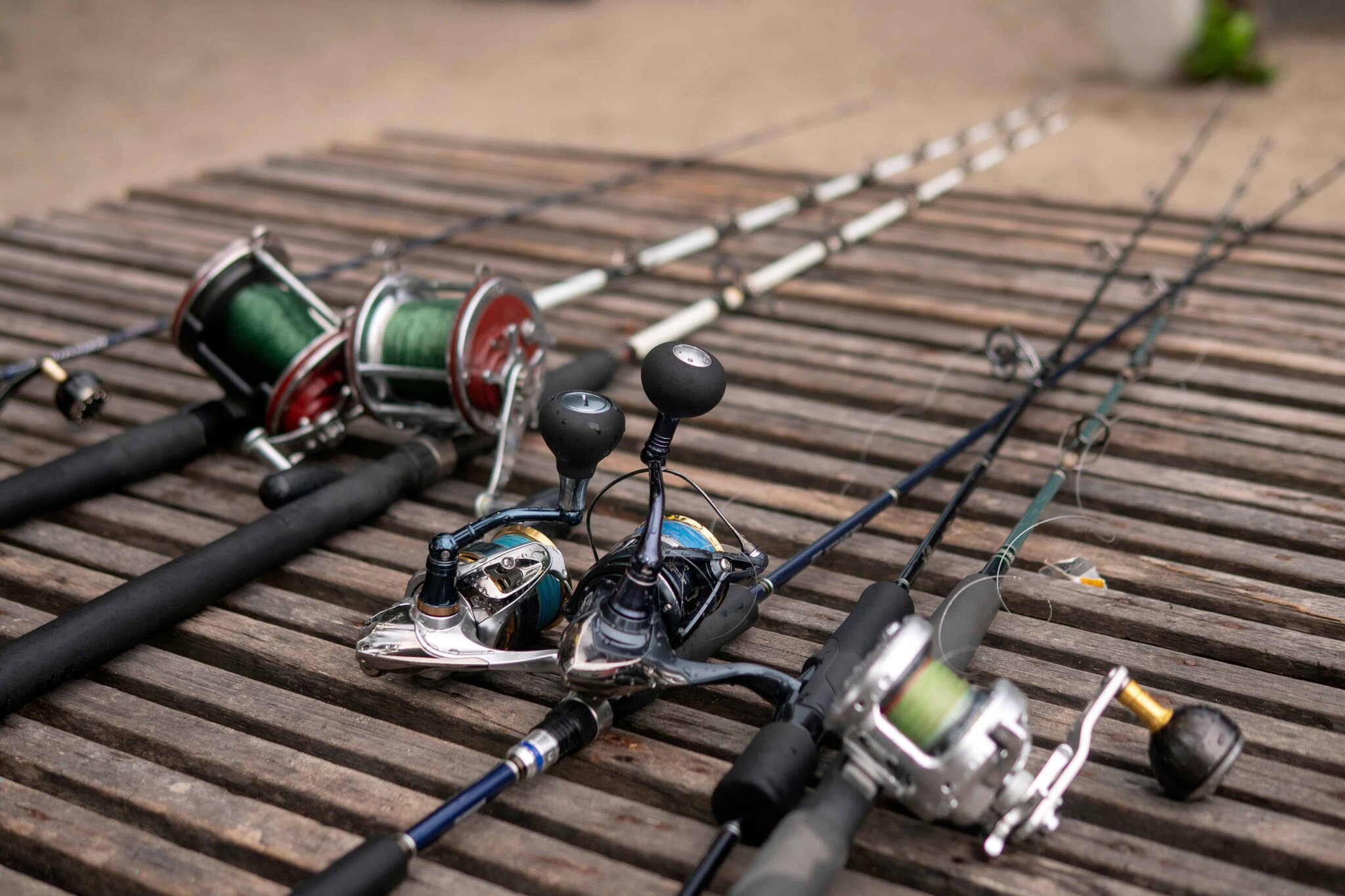 Fishing rods with line arranged on wood in morning light