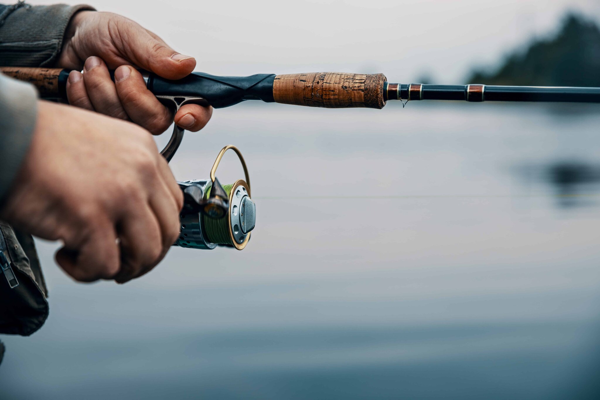 Angler fishing a river in early-morning light