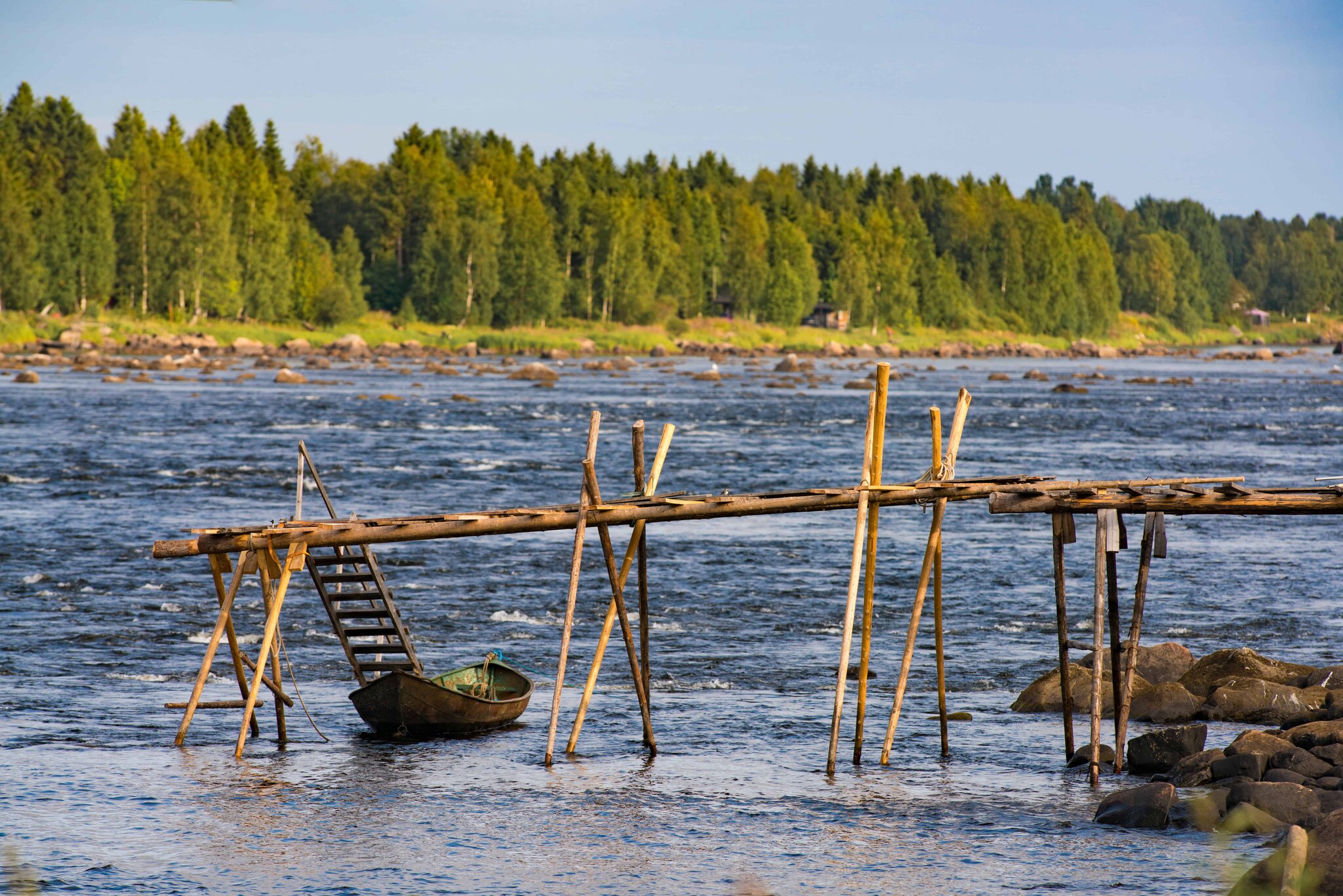 Traditional river fishing scene on the Kukkola River in northern Scandinavia