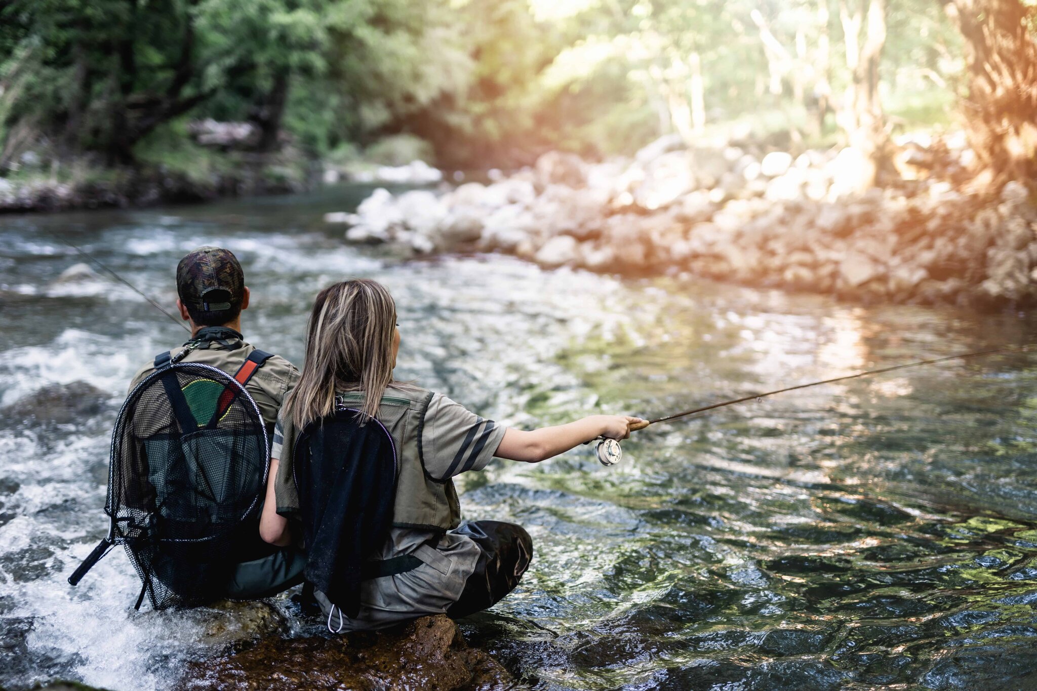 Two anglers fly fishing together in a fast mountain river