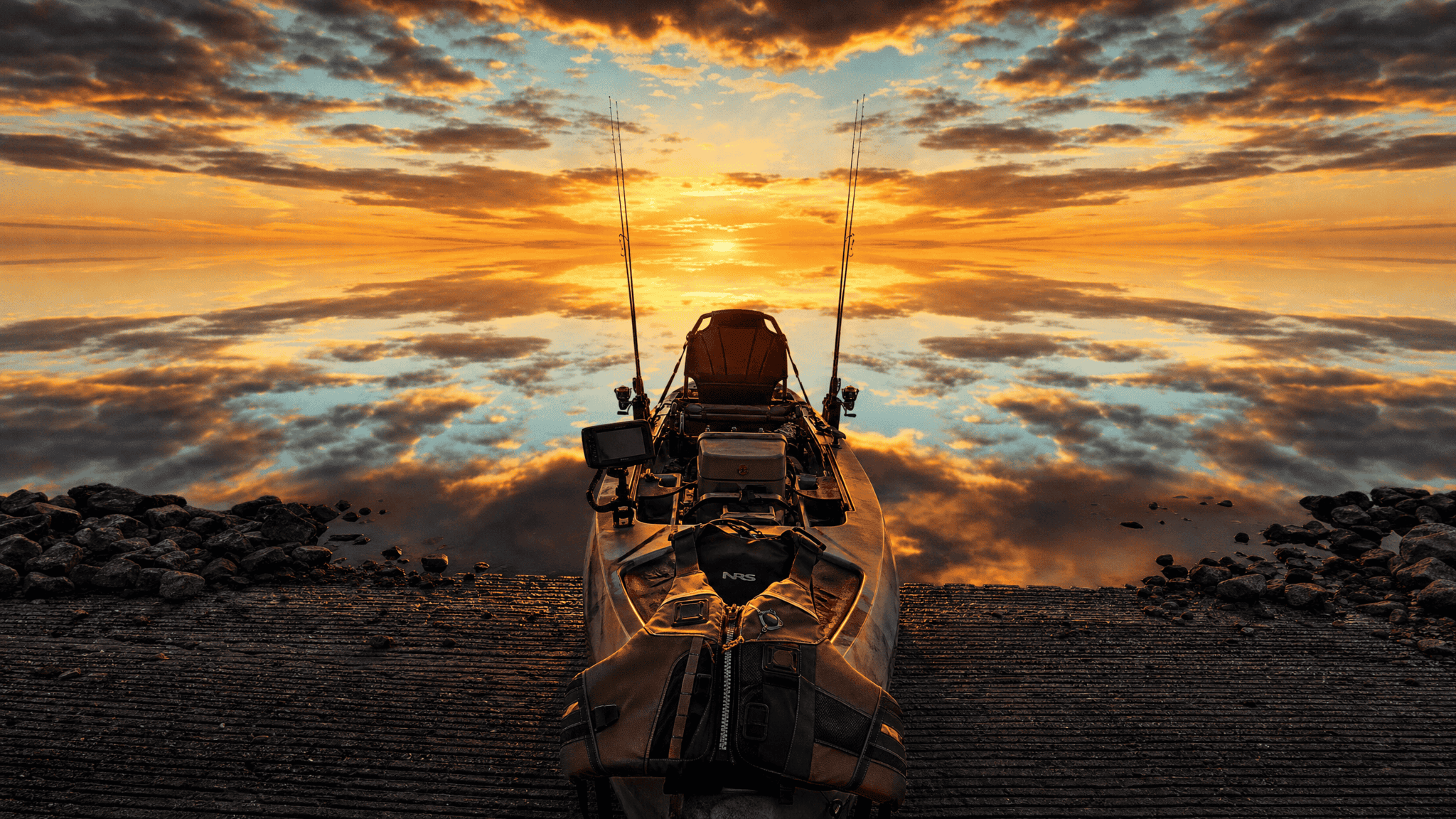 A fishing kayak at a calm launch at first light, a life jacket draped over the bow in golden rim light, the still water mirroring the sky into a seamless glow.
