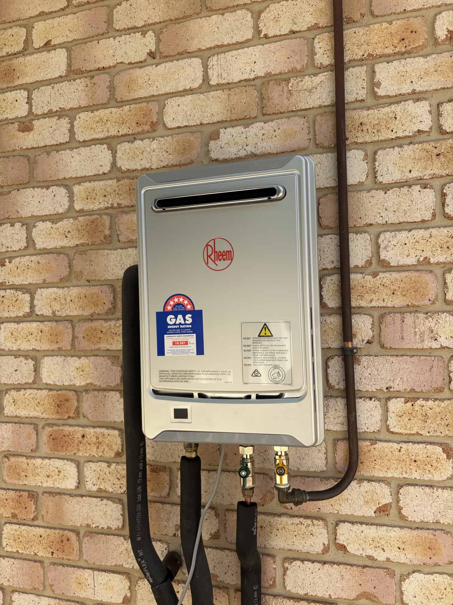 Old failed hot water unit before replacement in Woden.