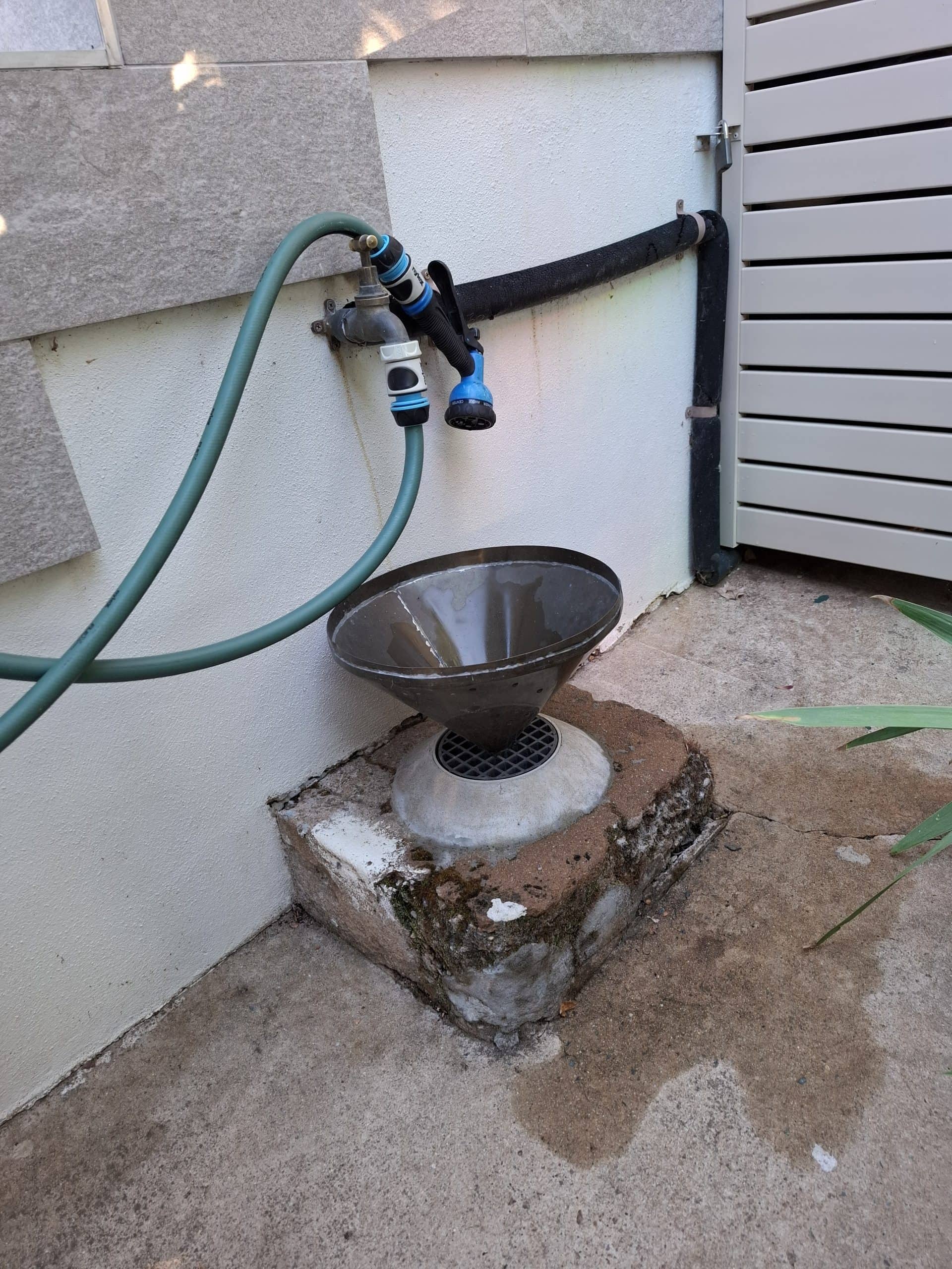 plumber clearing blocked gully trap in Scullin Canberra