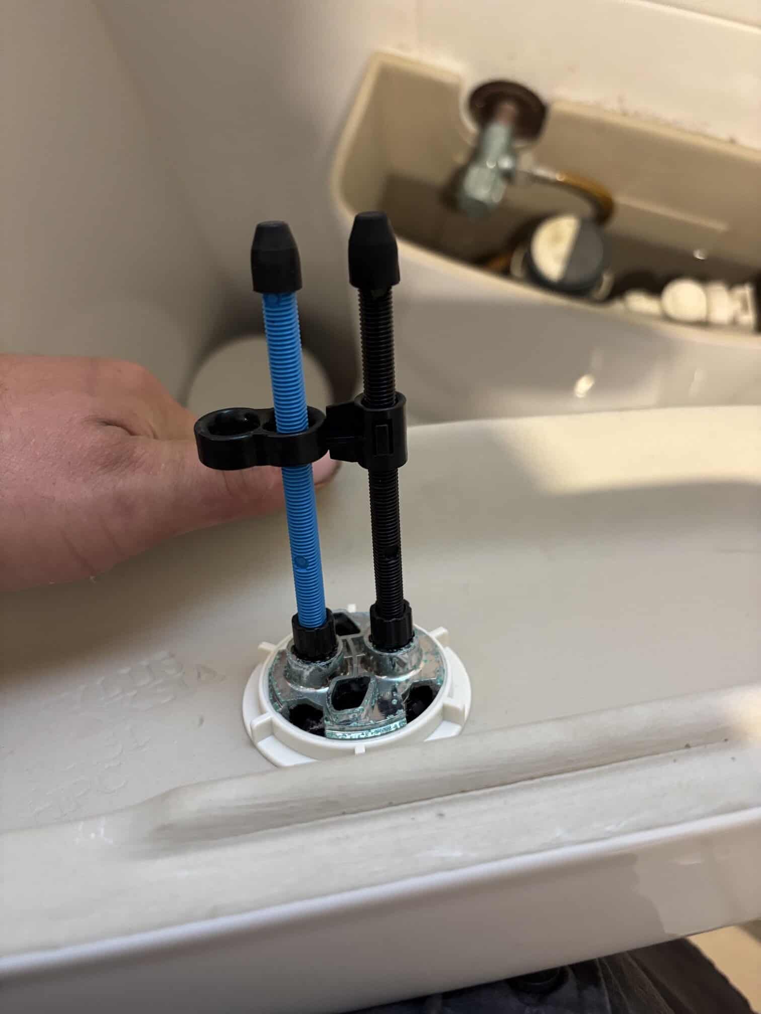 Toilet mechanism repaired and flush buttons realigned in Greenway home