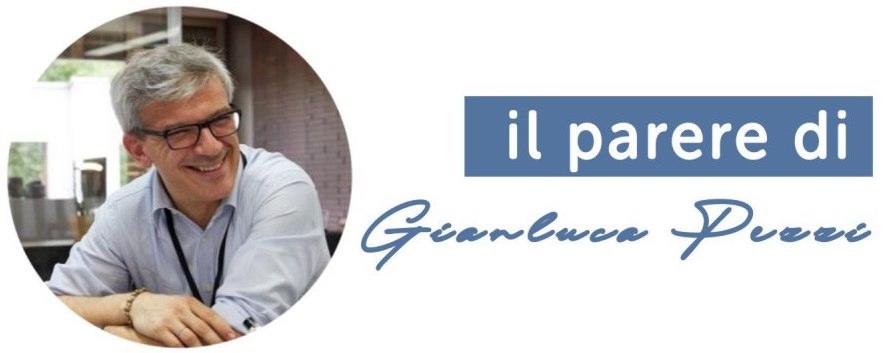 Ritratto ravvicinato di Gianluca Pezzi con occhiali e camicia chiara, in posa frontale su sfondo neutro.