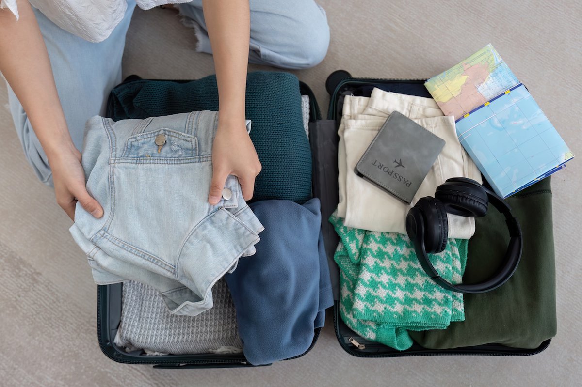 Woman and suitcase for travel summertime vacation packing clothing. relax and getaway preparation.
