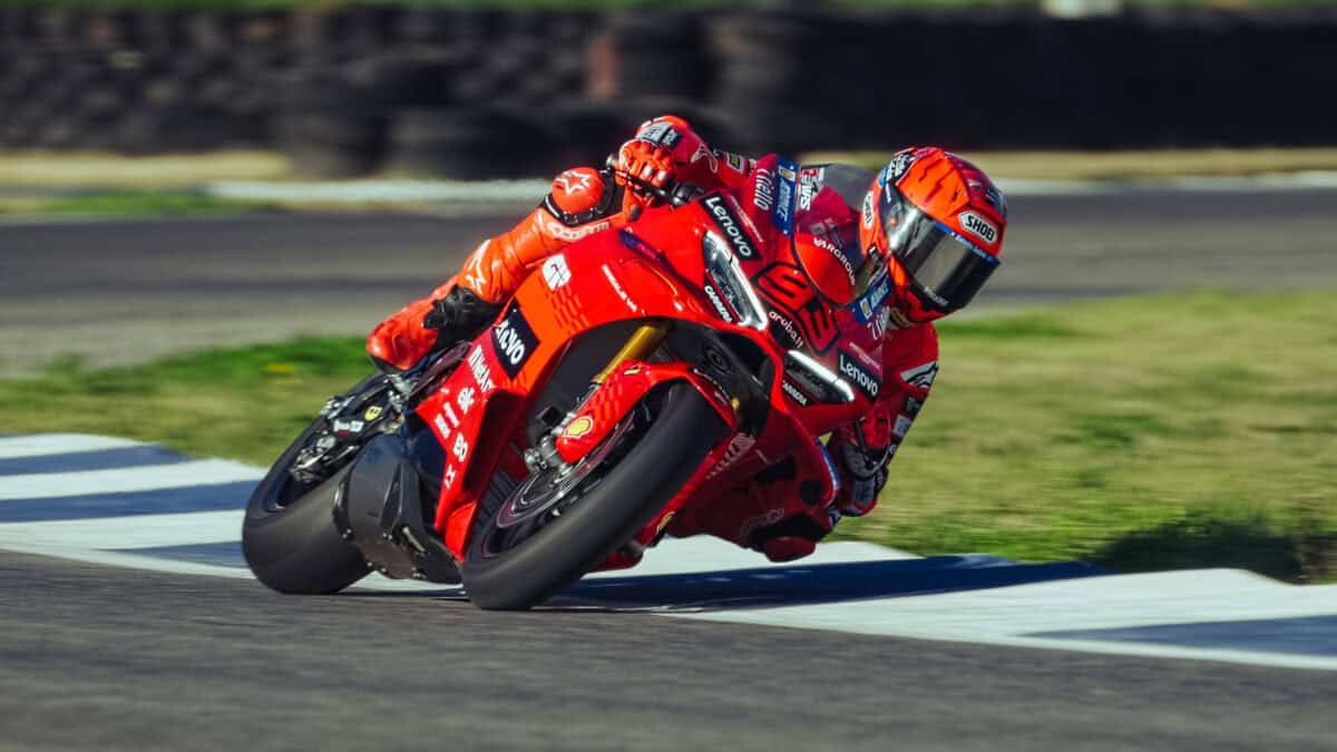 Marc Marquez in tuta rossa in piega su una Ducati Panigale V4 SBK 2026 durante un’azione in pista, con moto inclinata all’interno di una curva.